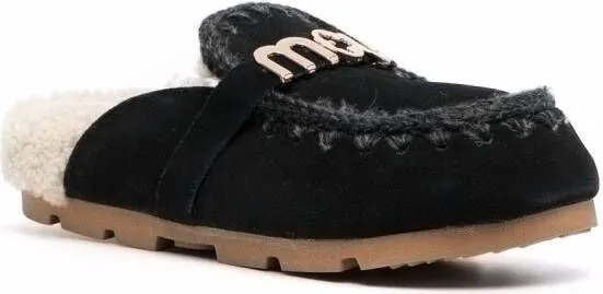 Black shearling slippers with logo plaque by Mou