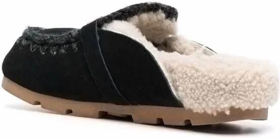 Black shearling slippers with logo plaque by Mou